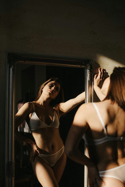 Woman in underwear reflected in a mirror