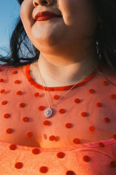 Close-up of a woman's chin and neck against a blue sky