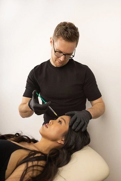 Dr. Matthias Spiegl administering an injection to a patient