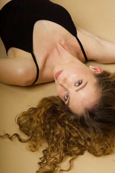 Woman lying down, head tilted back, seen from above