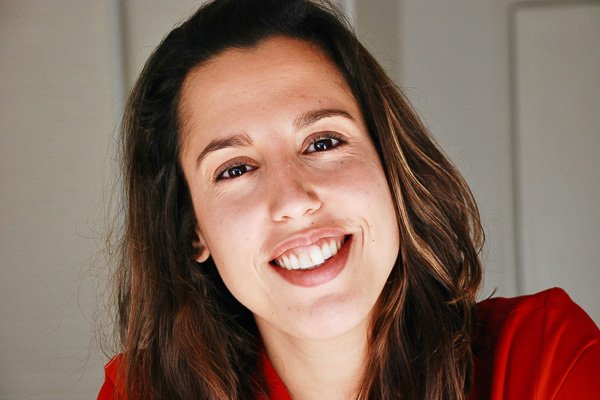Smiling woman in a red top, close-up portrait